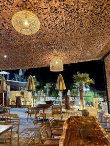 a restaurant with tables and chairs and umbrellas at Bianca Hotel & Villa in Tirana