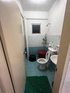 a bathroom with a toilet and a sink at AB HOMESTAY PUTERI BAHANG APARTMENT in Kota Kinabalu