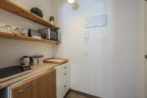 a kitchen with a counter and a refrigerator at Puerta del Sol Apartamento economico in Madrid