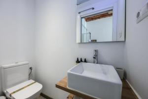 a white bathroom with a sink and a toilet at Puerta del Sol Apartamento economico in Madrid