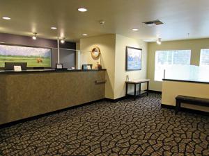 a waiting area of a hotel with a reception desk at Aspen Suites Hotel Kenai in Kenai