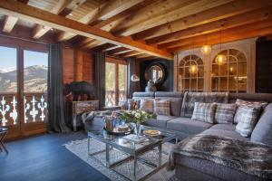 a living room with a couch and a table at Chalet Ruisselet - OVO Network in Châtel