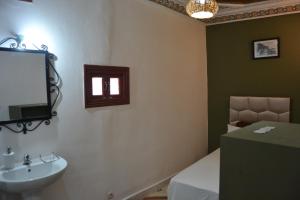 a bathroom with a sink and a mirror at Riad el Boukhiri in Marrakech