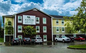 a aspen guest hotel with cars parked in a parking lot at Aspen Suites Hotel Kenai in Kenai