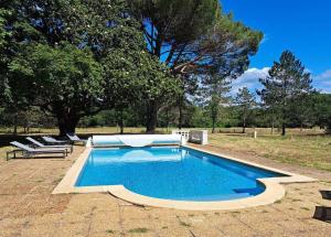 a swimming pool with lounge chairs around it at Grandiflora in Saint-Julien-en-Born