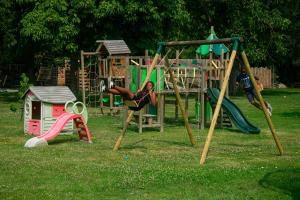 a woman is playing on a playground at Gîtes sympa, prés du zoo de beauval, "Au Havre de Paix" in Couffy