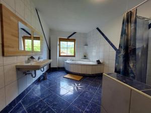 a bathroom with a tub and a sink at Mandla's Hoamat in Umhausen +31 photos