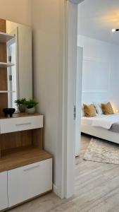 a bedroom with a bed and a mirror at The Nest in Floreşti