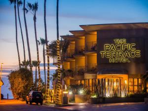 a hotel with a sign that reads the pacific terrace hotel at Pacific Terrace Hotel in San Diego