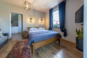 a bedroom with a bed and a large window at Apartamenty 33 in Zakopane