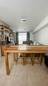 a large wooden table in a living room at Bragado Siempre 247 in Bragado +9 photos