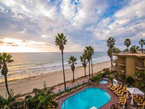 a view of the beach from the balcony of a resort at Pacific Terrace Hotel in San Diego