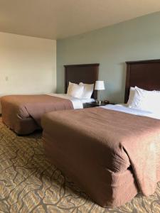 two beds sitting next to each other in a hotel room at Aptel Studio Hotel in Anchorage