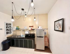 a kitchen with a refrigerator and a sink at H&H 1 Guest House in Malacca