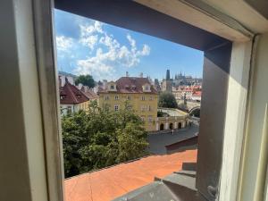 a view of a city from a window at River View Residence by Charles Bridge in Prague