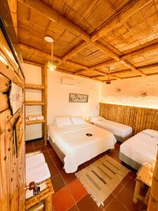 2 Betten in einem Zimmer mit Holzdecken in der Unterkunft Casa Gabriel Rivera in Rivera
