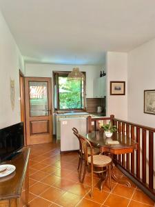 a kitchen with a table and a table and chairs at CASA VACANZE CERNIZZA in Duino