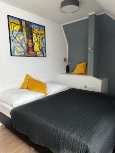 a bedroom with a bed and a stained glass window at Boutique Hotel VIVA CREATIVO in Hannover