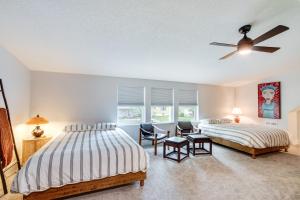 a bedroom with two beds and a ceiling fan at Bright and Sunny Getaway with Bikes 1 Mi to ESU! in Emporia +30 photos