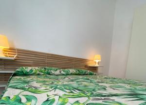 a bedroom with a bed and a wooden headboard at Villa Marhù in Mattinata