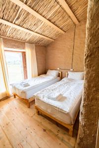 Voodi või voodid majutusasutuse KyzArt Hotel & Horse Tours toas