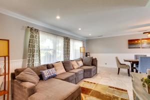 A seating area at Pool and Screened-In Patio Tropical Florida Abode