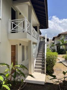 a stairway leading up to a white house at Finest Accommodation Renfrew Place 1 Bedroom Apt # 42 New Kgn 4--12 Renfrew Rd in Kingston