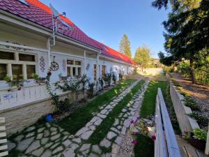 a house with a garden in front of it at Apartmány Nad Kostolom in Betliar