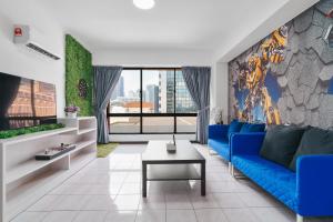 a living room with a blue couch and a table at Bukit Bintang Times Sq Lalaport Pool Table 76 in Kuala Lumpur