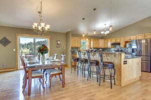 a dining room with a table and chairs and a kitchen at Mountain-View Rental with Hot Tub - 9 Mi to Helena! in Clancy