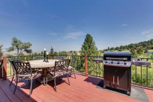 a patio with a table and a grill on a deck at Mountain-View Rental with Hot Tub - 9 Mi to Helena! in Clancy