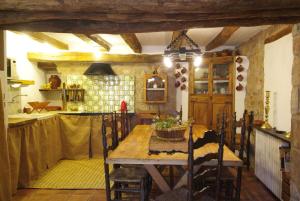 eine Küche mit einem Holztisch und einem Esszimmer in der Unterkunft Mas El Soler de Terrades - Turisme Rural in Moià