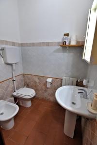 a bathroom with a toilet and a sink at Villa Very in Marina di Campo