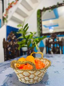 a basket of tomatoes sitting on a table at Paula's Tagaytay Transient House in Tagaytay