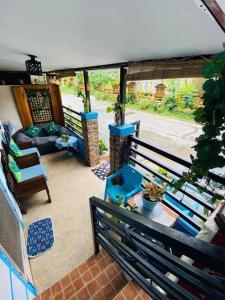 a balcony with a patio with a couch and a table at Tagaytay Budget House in Tagaytay