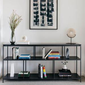 a black book shelf with books and a lamp at The Study at Johns Hopkins in Baltimore