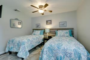 a bedroom with two beds and a ceiling fan at Coastal Getaway with Porch, 2 Mi to Niantic Beach! in Niantic