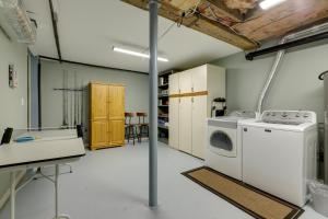a laundry room with a washer and dryer in it at Coastal Getaway with Porch, 2 Mi to Niantic Beach! in Niantic