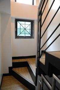 a staircase with a window in a house at Maison Dos 3 bedroom, with 200mbps internet speed, netflix and aircon in Antipolo