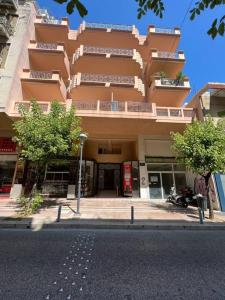 a large apartment building on the side of a street at Αγρίνιο κέντρο ΠA , A3 in Agrinio