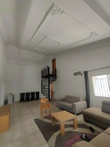 a living room with a couch and a table at Eli Ndatis Self Catering Apartments in Kololi
