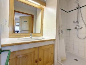 a bathroom with a sink and a mirror and a shower at Appartement spacieux au pied des pistes avec balcon - FR-1-344-1011 in Les Bruyères +9 photos
