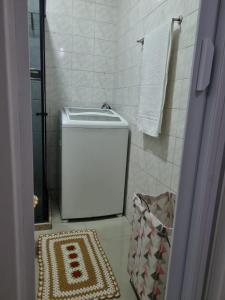 a bathroom with a toilet and a rug in it at Flat Reformado no centro histórico RJ in Rio de Janeiro