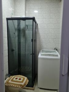 a shower in a bathroom with a toilet and a sink at Flat Reformado no centro histórico RJ in Rio de Janeiro