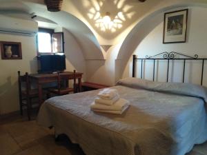 a bedroom with a bed with two towels on it at Raggio Di Sole in Alberobello