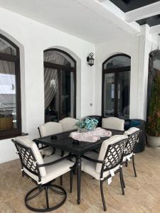 a dining room table with chairs and a table at Pensiunea Baroc in Braşov