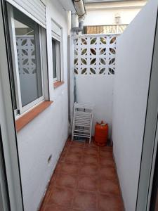 a small hallway with a window and a tiled floor at Holiday apartment in Puerto de Sagunto