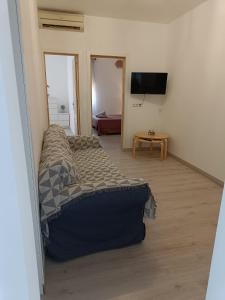 a living room with a couch and a television at Holiday apartment in Puerto de Sagunto