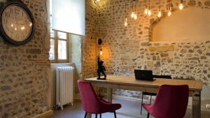 a room with a table with a laptop and chairs at Villa Pona in Digoin