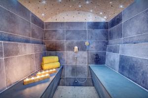 a bathroom with a tub and a yellow chair in it at Chalet Ladroit - OVO Network in Les Clefs